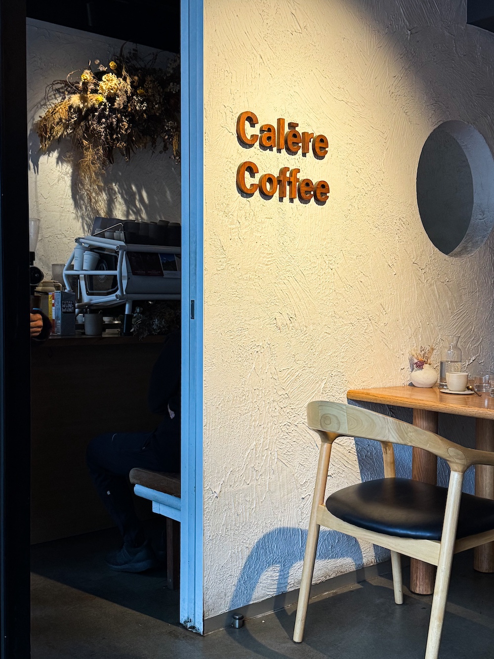 A coffee shop wall with a sign ‘Calare Coffee’.